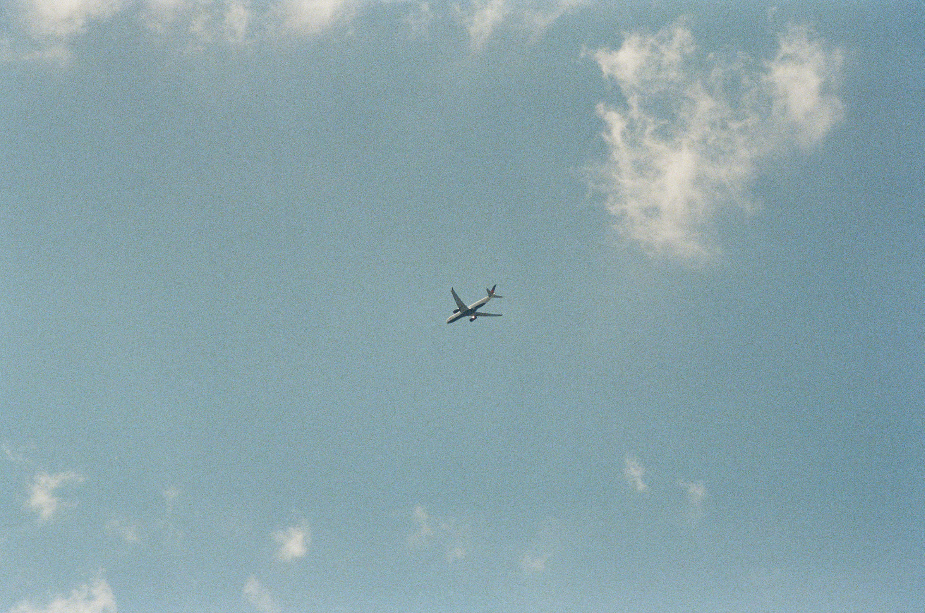 A small silhouette crossing an endless blue.